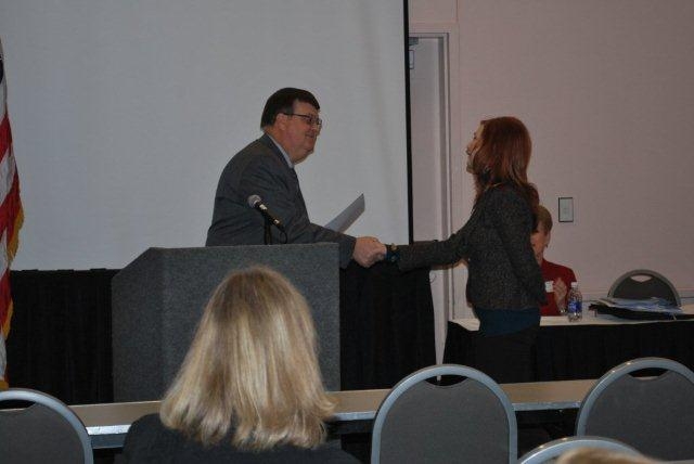 Lora
                    Redick congratulated by Tim Piper, Allen County
                    Engineer
